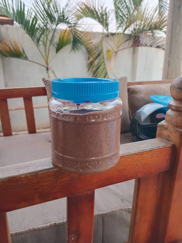 A single jar of groundnut paste on banister
